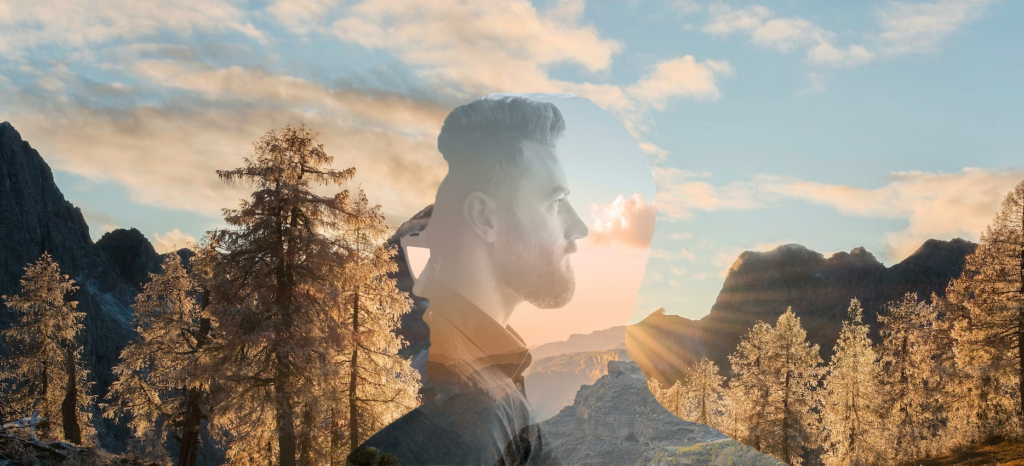 Picture of a man experiencing the entourage effect, with a mountainous landscape in the background